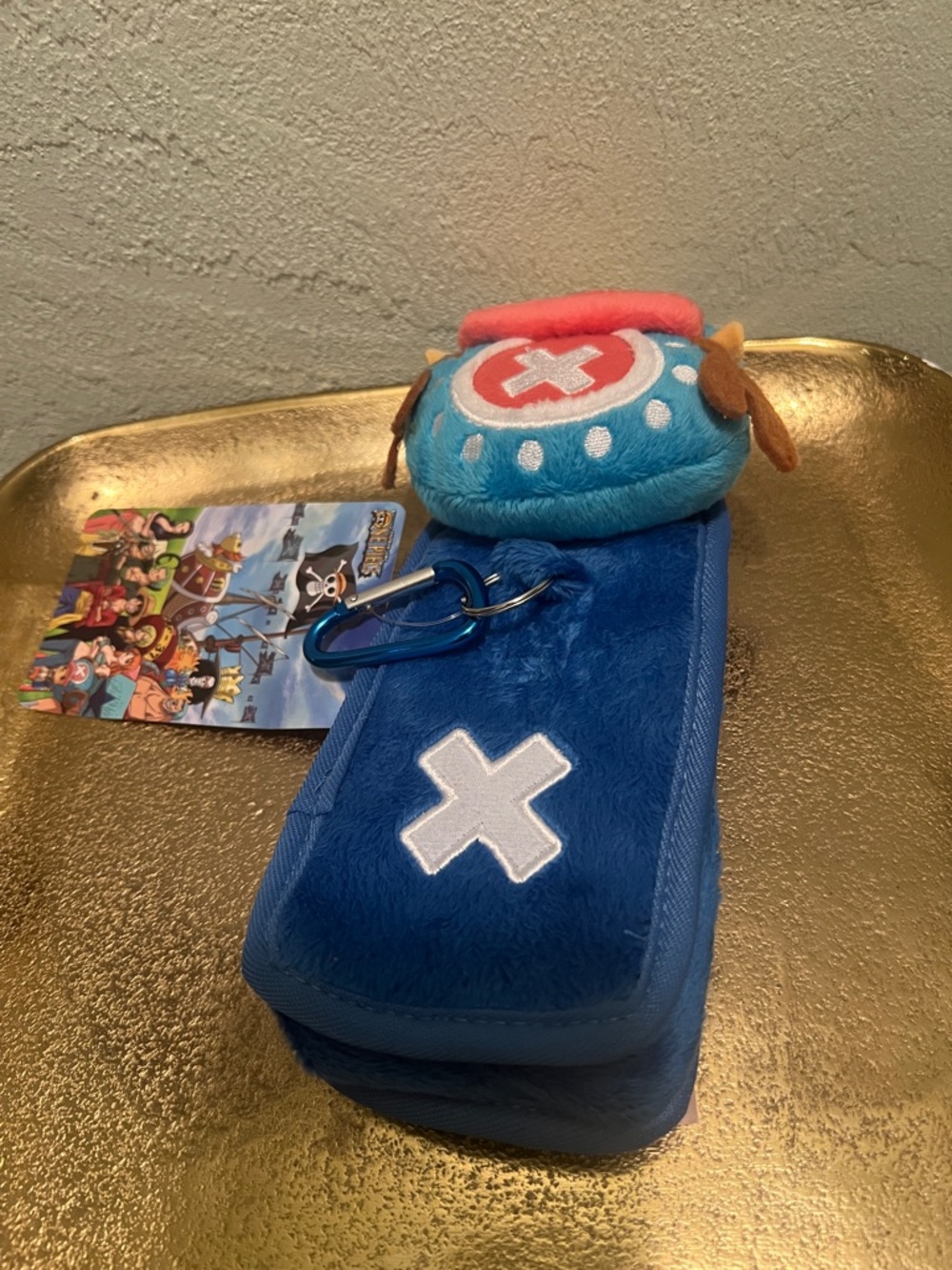 #1831: Unisex’s One Piece Anime Blue Plush Keychain Pouch with Cross Accent